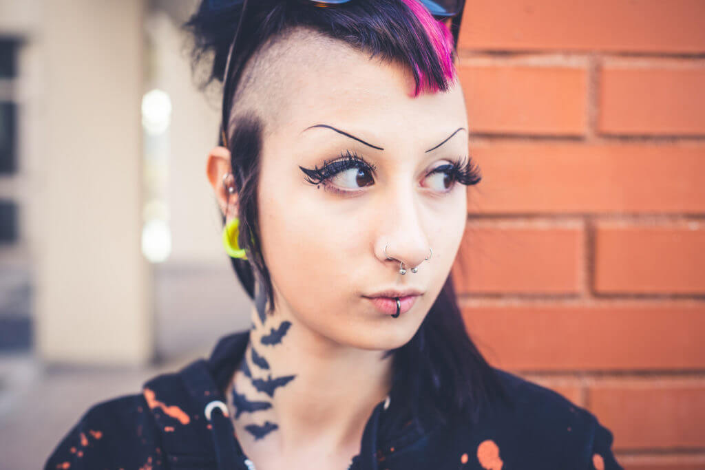 young beautiful punk dark girl in urban landscape